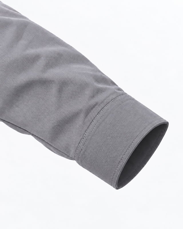Grey work jacket cuff reference Reference illustration of a grey work jacket sleeve with a straight cuff opening and tonal edge stitching.
