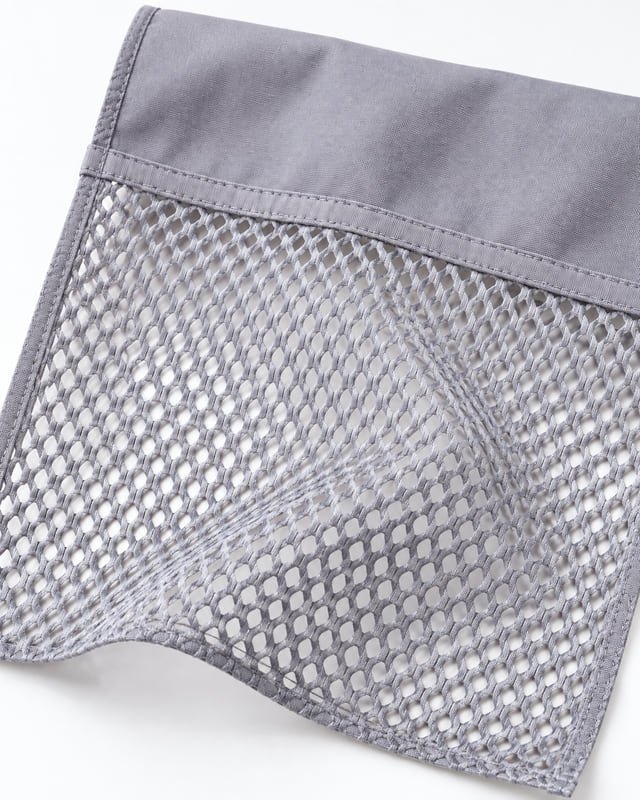 Reference illustration of grey open mesh joined to a solid fabric panel with a stitched edge.