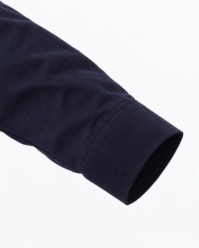 Work jacket sleeve opening and stitching Reference illustration of a dark navy jacket sleeve showing the cuff opening and tonal edge stitching.